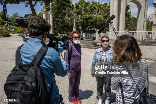 Reporters interview the first visitors in the main park of Catania Villa Bellini, now open after the lockdown on May 04, 2020 in Catania, Italy....