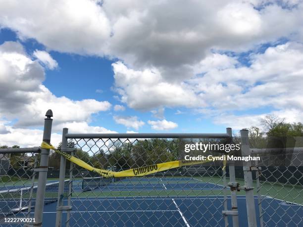 yellow caution tape across the entrance to tennis courts - out of bounds sport stock pictures, royalty-free photos & images