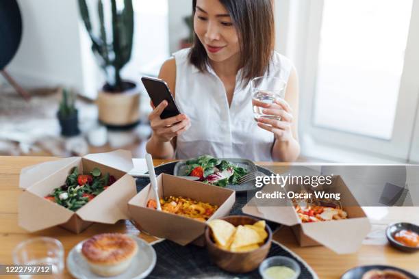 Eating Takeout Phone Photos and Premium High Res Pictures - Getty Images