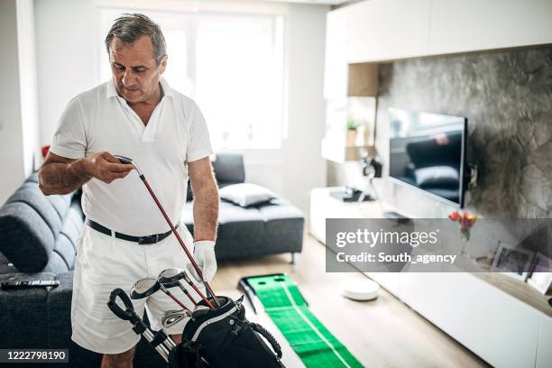 man choosing the right golf club for next hit - golf club house stock pictures, royalty-free photos & images