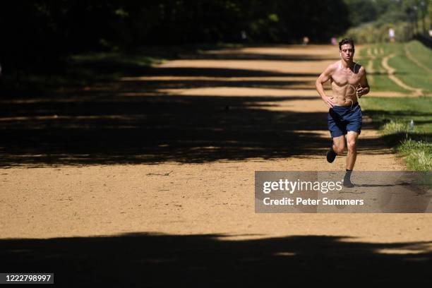 Man is seen running topless in Hyde Park on June 25, 2020 in London, United Kingdom. The UK is experiencing a summer heatwave, with temperatures in...