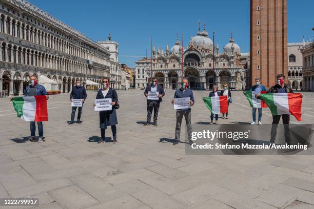 Militants of the Italian party "Fratelli d'Italia" take part in the flashmob in St. Mark's Square to ask for the immediate reopening of business...