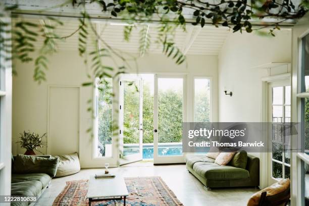 living room overlooking backyard pool - luxury backyard stock pictures, royalty-free photos & images