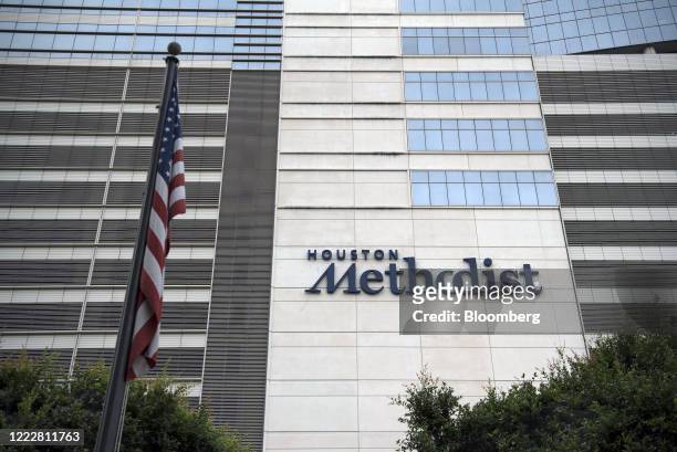 An American flag flies outside the Houston Methodist Hospital at the Texas Medical Center campus in Houston, Texas, U.S., on Wednesday, June 24,...