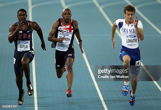 Justin Gatlin of United States, Marlon Devonish of Great Britain and Christophe Lemaitre of France competes in the men's 100 metres heats during day...