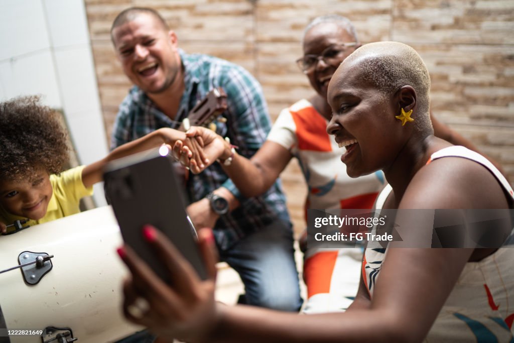 Family on a video chat while playing music at home - video chat