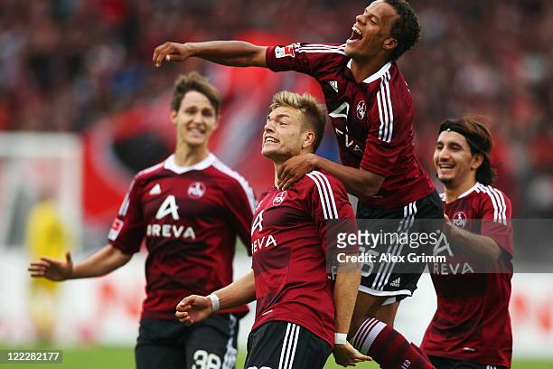 Alexander Esswein of Nuernberg celebrates his team's first goal with team mates n38, Timothy Chandler and Almog Cohen during the Bundesliga match...