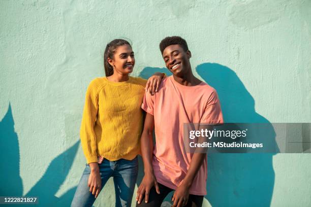 young smiling couple. - friendship men yellow stock pictures, royalty-free photos & images