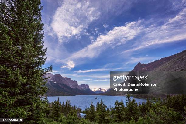 sunny day over little goose island, st. mary"u2019s lake, glacier national park, montana - kalispell stock pictures, royalty-free photos & images