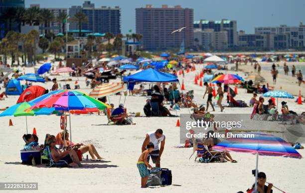 People visit Clearwater Beach after Governor Ron DeSantis opened the beaches at 7am on May 04, 2020 in Clearwater, Florida. Restaurants, retailers,...