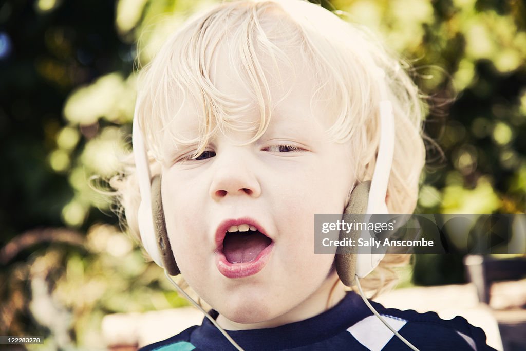 Child wearing retro headphones on singing