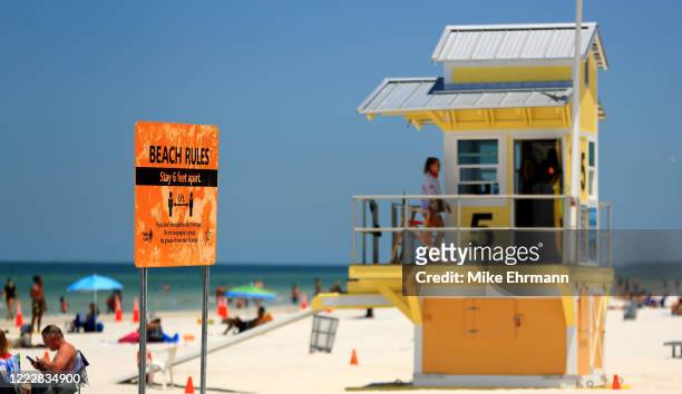 Sign displays the rules as people visit Clearwater Beach after Governor Ron DeSantis opened the beaches at 7am on May 04, 2020 in Clearwater,...