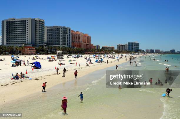 People visit Clearwater Beach after Governor Ron DeSantis opened the beaches at 7am on May 04, 2020 in Clearwater, Florida. Restaurants, retailers,...