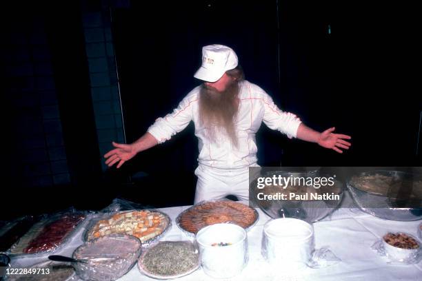 American Rock musician Dusty Hill, of the group ZZ Top, poses at the craft services table backstage at the Metro Center, Rockford, Illinois, February...