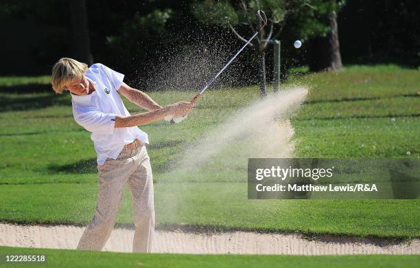 Thomas Detry of the Continent of Europe plays out of a bunker during his Singles match against Toby Tree of Great Britain and Ireland during the...