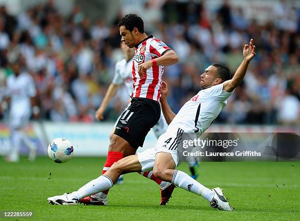 Keiran Richardson of Sunderland battles for the ball with Steven Caulker of Swansea City during the Barclays Premier League match between Swansea...