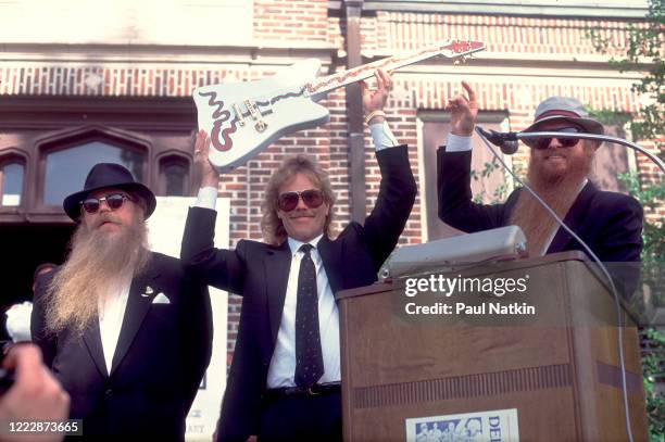 Members of the American Rock group ZZ Top present the 'Muddywood' guitar to the Carnegie Public Library's Delta Blues Museum, Clarksdale,...