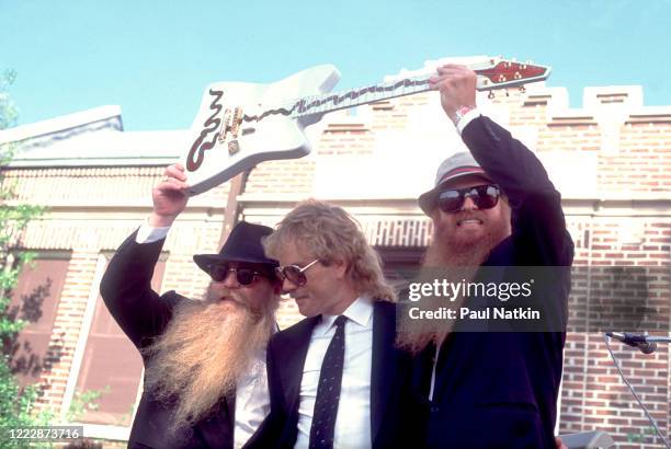 Members of the American Rock group ZZ Top present the 'Muddywood' guitar to the Carnegie Public Library's Delta Blues Museum, Clarksdale,...