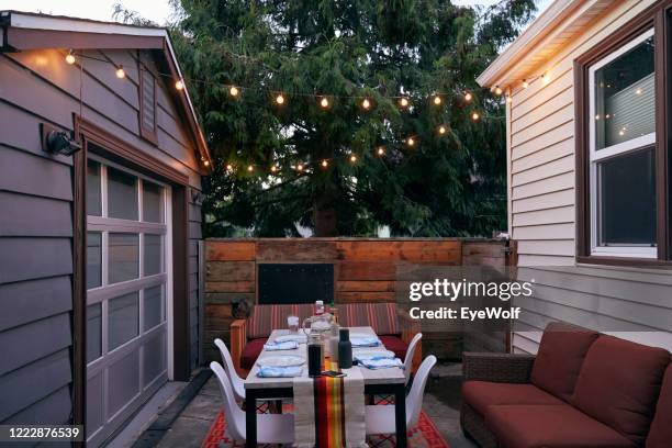 a dinner table set up outside in the evening in may. - build grill stock pictures, royalty-free photos & images