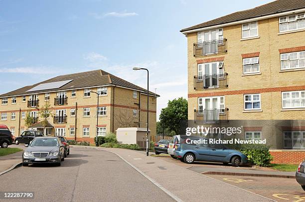 homes with cars parked, uk - suburban apartments stock pictures, royalty-free photos & images