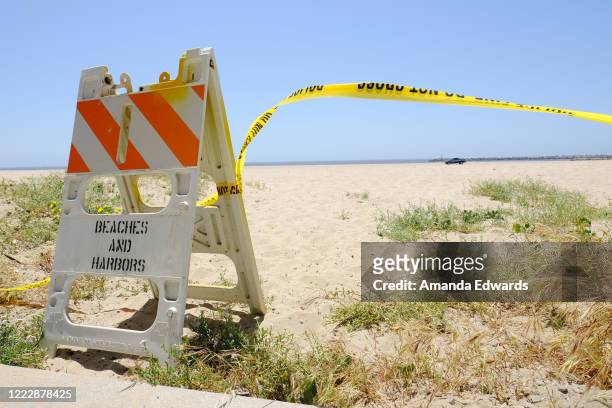 Police tape prohibiting access to the beach is seen during the coronavirus pandemic on May 04, 2020 in Playa del Rey, California. The coronavirus...