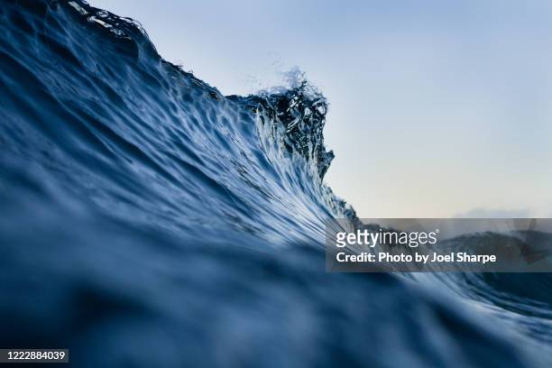 the lip of a silky blue wave - sea stock pictures, royalty-free photos & images