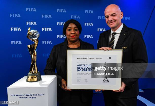 Secretary General Fatma Samoura and FIFA President Gianni Infantino pose with the Women’s World Cup Trophy after the announcement that...