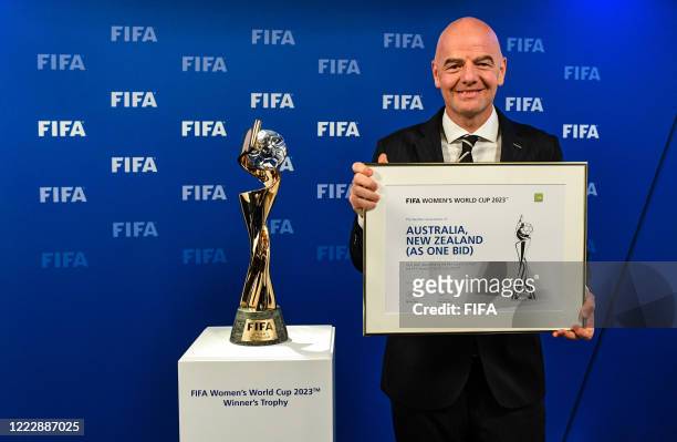 President Gianni Infantino pose with the Women’s World Cup Trophy after the announcement that Australia/New-Zealand are the winning host’s for the...