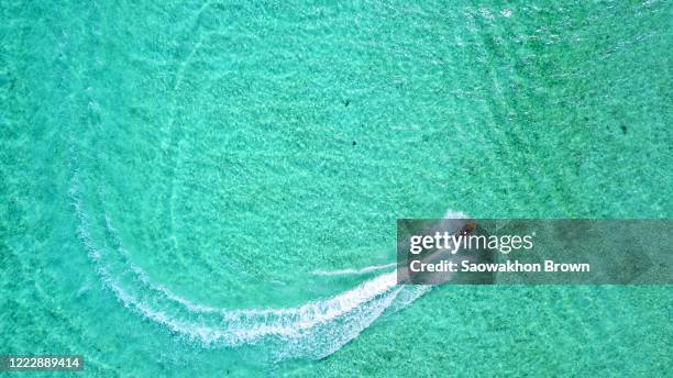 above view of tourist couple enjoy playing a jet ski in the sea in summer - maldives sport stock pictures, royalty-free photos & images