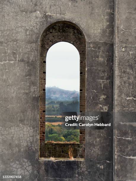 view through window of martha mine pumphouse, waihi, new zealand, north island. - martha mine stock pictures, royalty-free photos & images