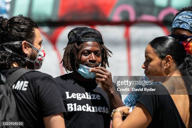 Marcus Henderson , an organizer within the Capitol Hill Organized Protest , speaks with other organizers after holding a press conference in the CHOP...
