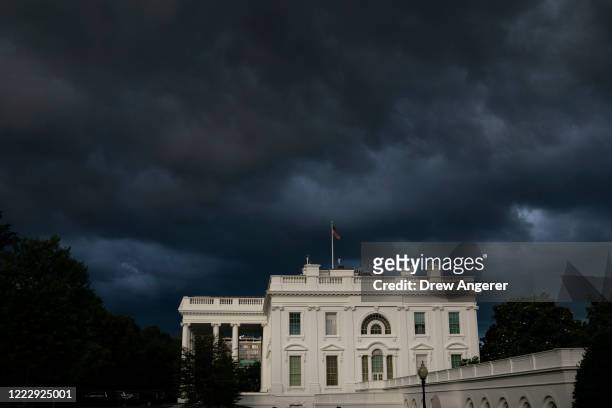 Storm clouds are seen near the White House Thursday evening on June 25, 2020 in Washington, DC. President Donald Trump traveled to Wisconsin on...