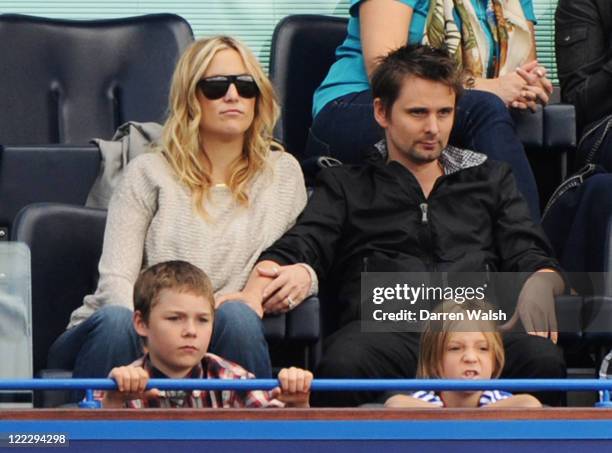 Actress Kate Hudson and Muse lead singer Matthew Bellamy with Hudson's son Ryder Russell Robinson watch during the Barclays Premier League match...