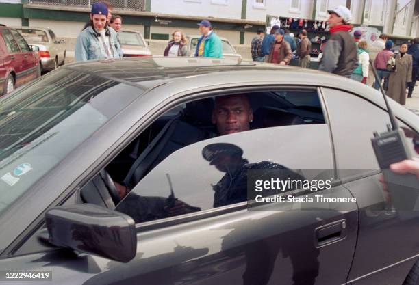 Michael Jordan driving a car outside Wrigley Field on opening day, April 4, 1993 in Chicago, Illinois, United States.