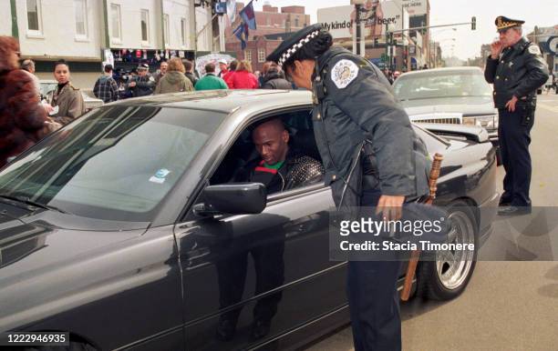 Michael Jordan signs an autograph for a Chicago Police officer outside Wrigley Field on opening day, April 4, 1993 in Chicago, Illinois, United...