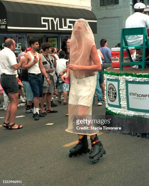 Person in a giant condom costume rollerblades backwards in the Chicago Gay Paride Parade on June 26, 1994 in Chicago, Illinois, United States.