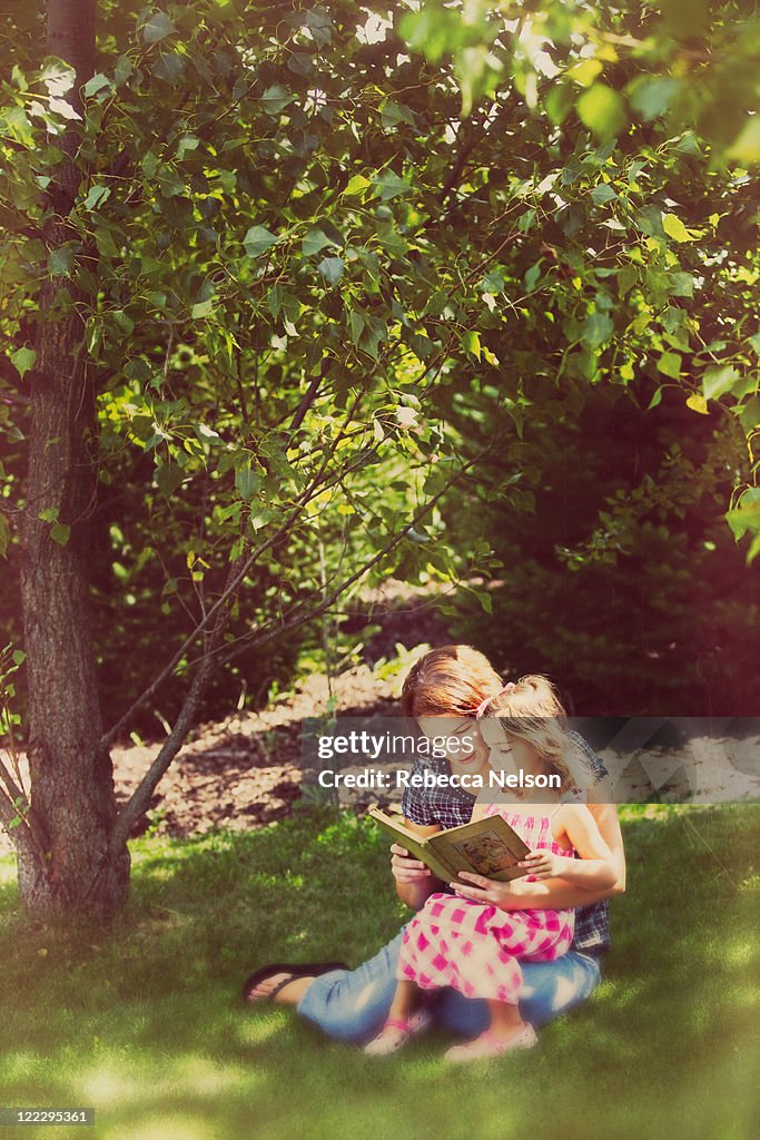 Mother reading and daughter on her lap