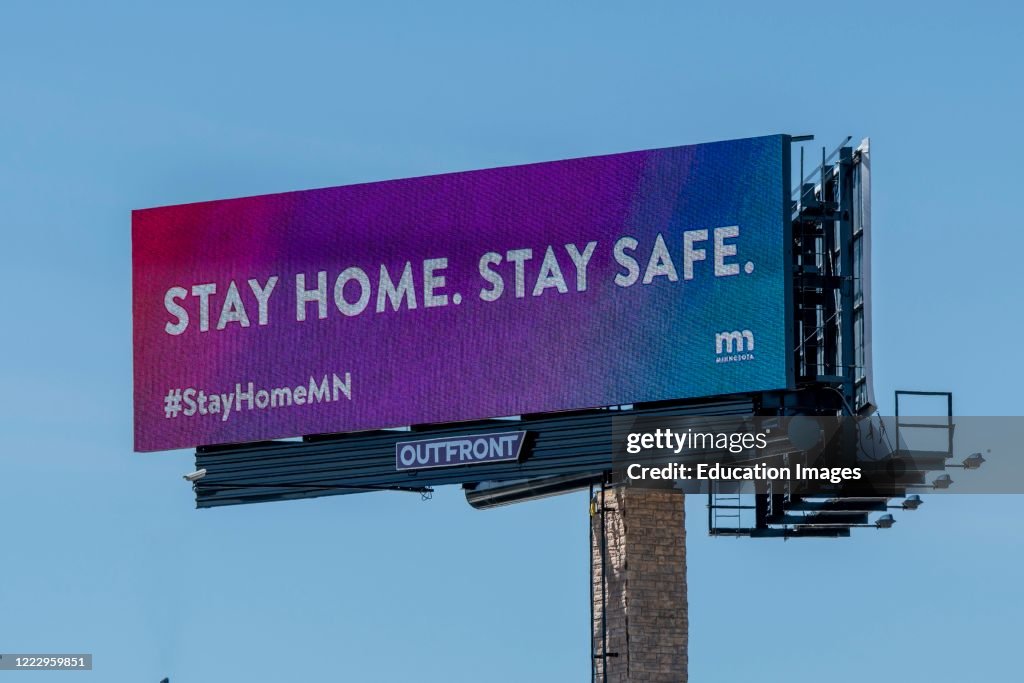 Billboard sign telling people to stay home and stay safe.