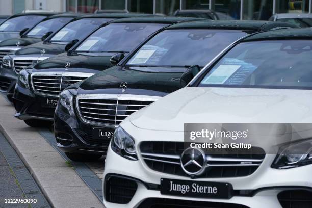 Cars stand on display for sale at a Mercedes-Benz dealership during the coronavirus crisis on May 05, 2020 in Berlin, Germany. German Chancellor...