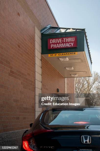 Little Canada, Minnesota, Customers use the drive thru pharmacy to pickup their prescriptions at a drugstore to keep their socisl distancing.