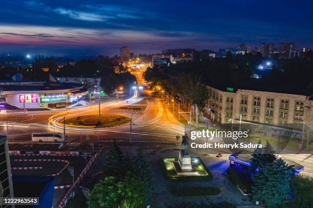 moldova, chisinau, cityscape illuminated at dusk - chisinau stock-fotos und bilder