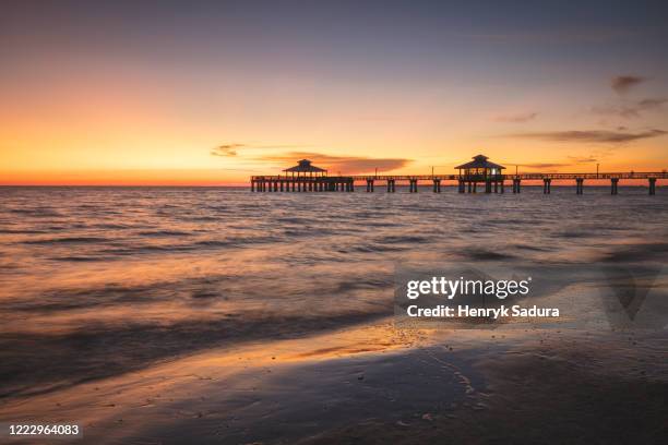 usa, florida, fort myers beach, pier in sea at sunset - fort myers stock-fotos und bilder