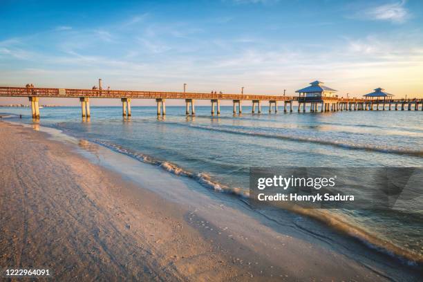 usa, florida, fort myers beach, pier in sea at sunset - fort myers stock pictures, royalty-free photos & images