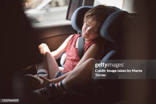 boy waking up in his carseat - loose stock pictures, royalty-free photos & images