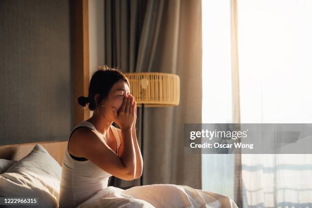 young woman waking up to a brand new day - yawning woman stockfoto's en -beelden