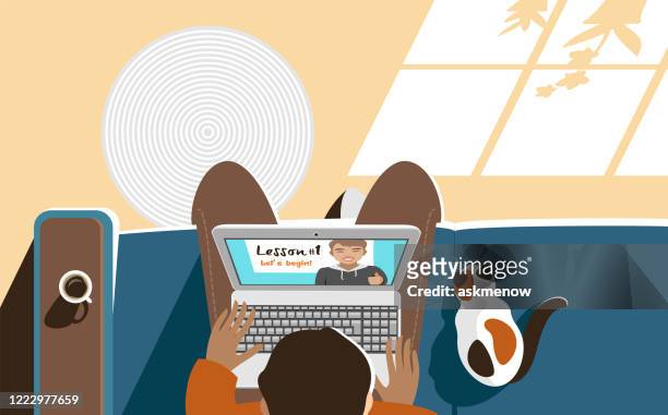 young man studying online at home - adult education stock illustrations