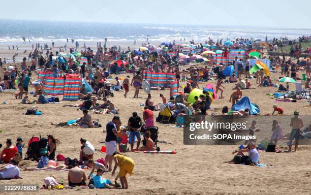 People enjoy the weather at the beach on the hottest day of the year. People head to the beach at the popular seaside resort of Skegness as England...