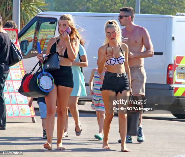 People walk to the beach on the hottest day of the year. People head to the beach at the popular seaside resort of Skegness as England records it's...