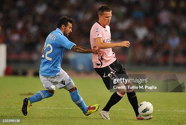 Ezequiel Lavezzi of Napoli and Josip Ilicic of Palermo compete for the ball during the pre season friendly match between SSC Napoli and US Citta di...