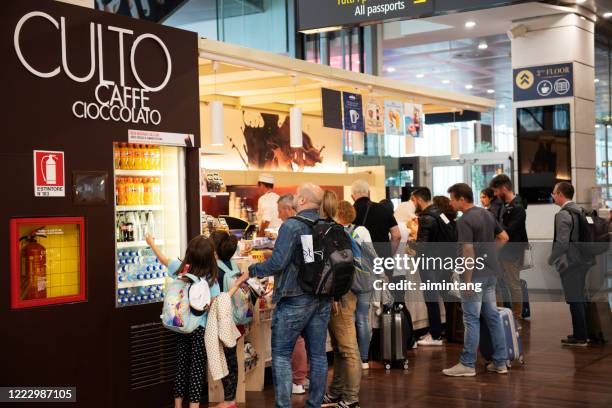 travelers waiting to buy food at culto caffe at the terminal of venice marco polo airport - venice airport stock pictures, royalty-free photos & images